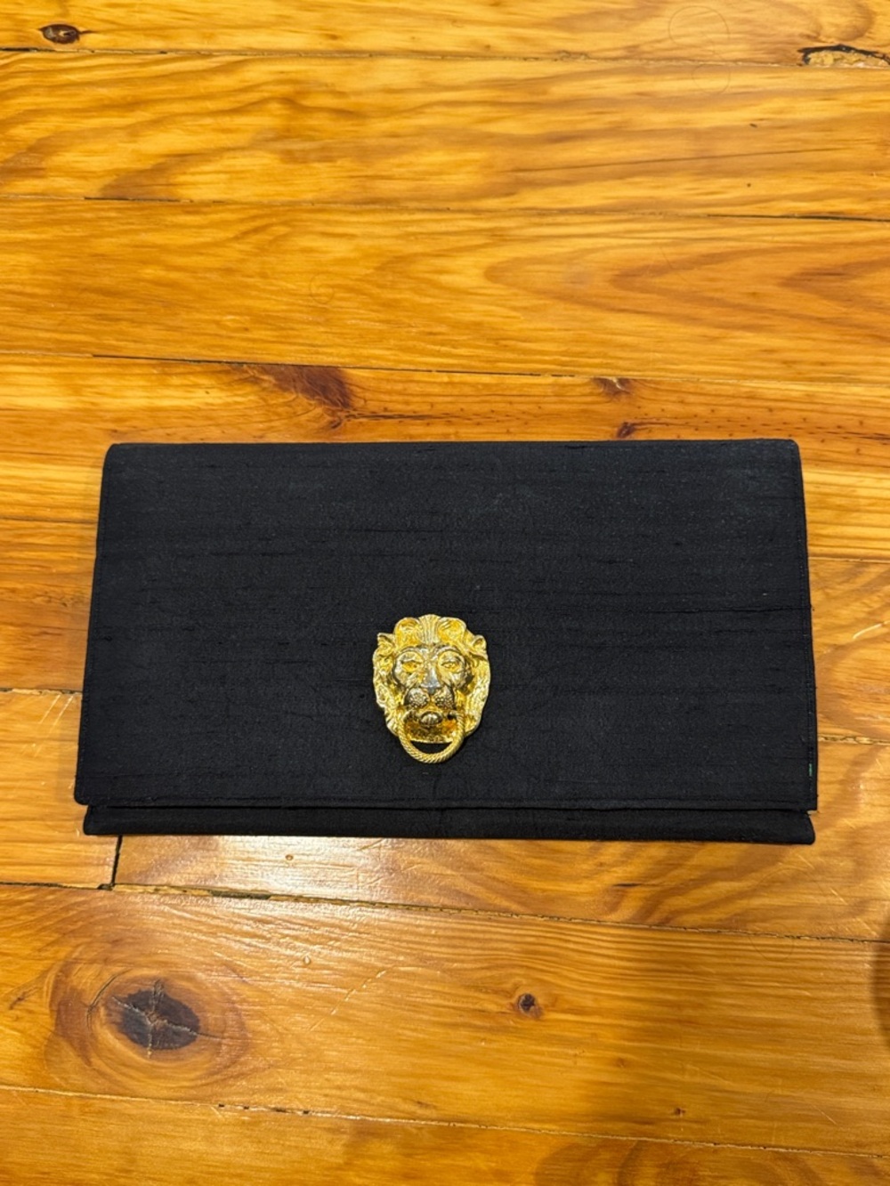 Elegant Black Clutch with Gold Lion Accent